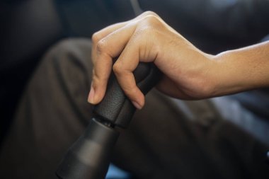 man hand switching a manual gear shift in the car