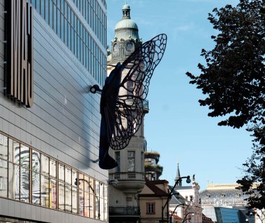 The two sculptures, representing butterflies with Spitfire aircraft wings of a vivid purple-blue color, were recently installed on the facades of the renovated Mj shopping center, located between Nrodn and Splen streets in Prague 1.