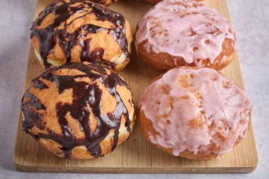 Tahtada çikolata ve şeker kaplı taze çörekler.