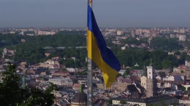 Légi lövés ukrán lobogója alatt tetején gyönyörű panoráma a város Lviv. — Stock videók