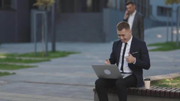 Man business coach giving online interview speaking on webcam laptop computer having distant meeting with boss outside office. Distance working. Isolated man on a suit — Stock Video