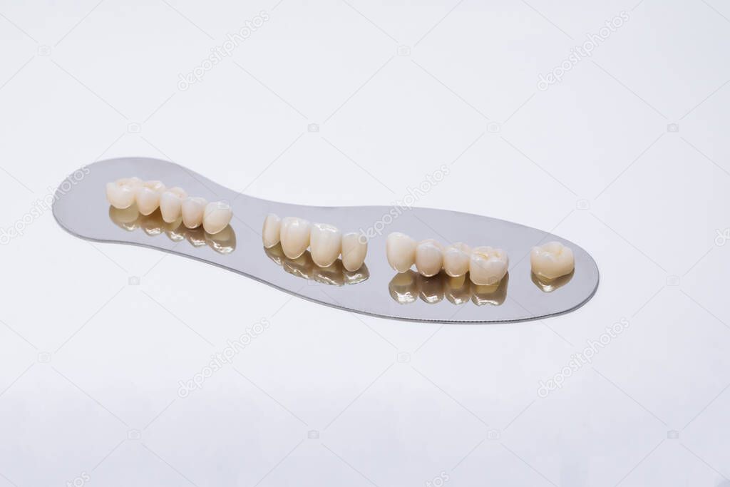 Ceramic zirconium in final version. Metal Free Ceramic Dental Crowns. Zirconium tooth crown. Isolate on background. Aesthetic restoration of tooth loss