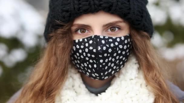 거리의 사람들에게 보호 마스크를 쓰고 있는 젊은 여경의 모습. 건강과 안전 , N1H1 코로나 바이러스 격리, 제2 웨이브 코덱 바이러스. 휴가철 야외에서 정어리 소녀 — 비디오