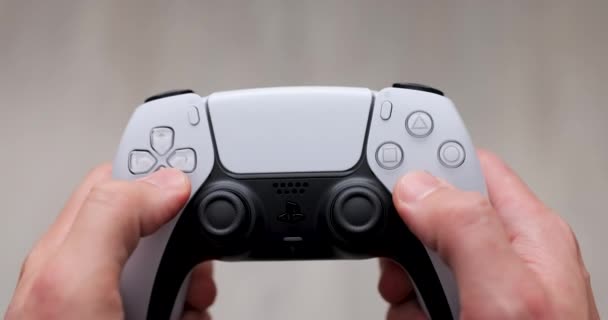 Man play with Playstation 5 Dual Sense controller. 27 Nov, 2020, Lviv, Ukraine. — Stock Video