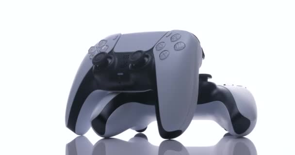 ÚJ YORK - 2021 február 27: Két joystick a Sony PlayStation 5 TV konzolról fehér háttérrel. Közelkép 2 vezérlő az új konzol fény — Stock videók