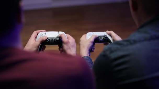 NEW YORK - March 7, 2021: Close view of a gamers hands playing soccer football simulator video game on console using joystick. Two joysticks from Sony PlayStation 5 TV game console — Stock Video