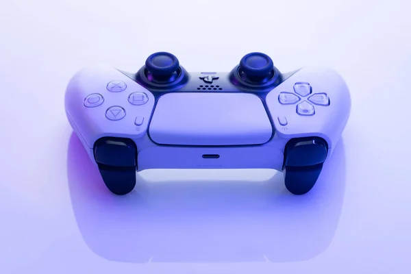 NEW YORK - March 3, 2021: Sony Playstation 5 controller. White controller from TV game box in blue light. One white game controller for Sony Playstation 5. — Stock Photo, Image