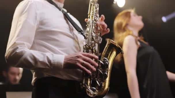 Saxophonist play on golden saxophone. Live performance. Jazz music. Cool saxophone player performing a solo on stage. Musician playing in band. — Stock Video