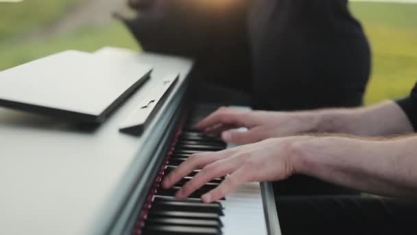 Man two hands plays gentle classical music on a grand piano. Professional pianist. Man touches fingers on keys . Pianist plays in beautiful grand piano in nature. — Stock Video