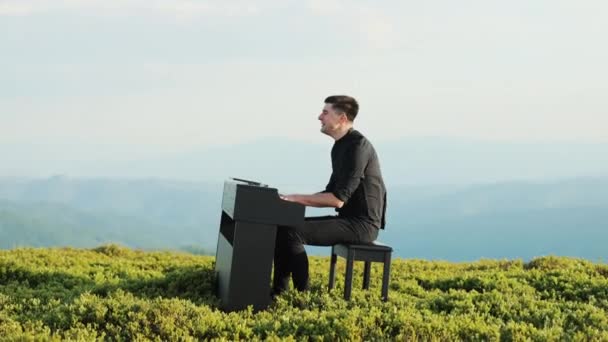 O homem toca nos dedos das chaves. Pianista toca em belo piano de cauda nas montanhas. Homem duas mãos toca a música clássica doce em um piano de cauda na natureza. Pianista profissional. — Vídeo de Stock