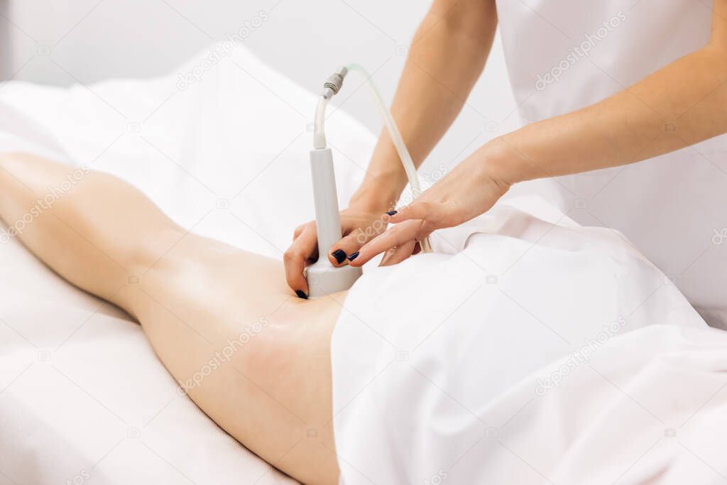 Vacuum massage of the buttocks. Female getting anti-cellulite and anti-fat therapy in beauty salon. Body care. Hardware cosmetology.