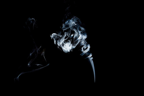 Transparent white smoke on black background.