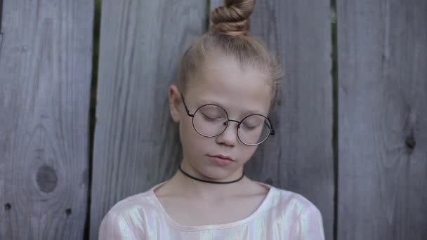 Beautiful Girl With Hair Bump Round Glasses Asleep on a Background of Wooden Fence — Stock Video