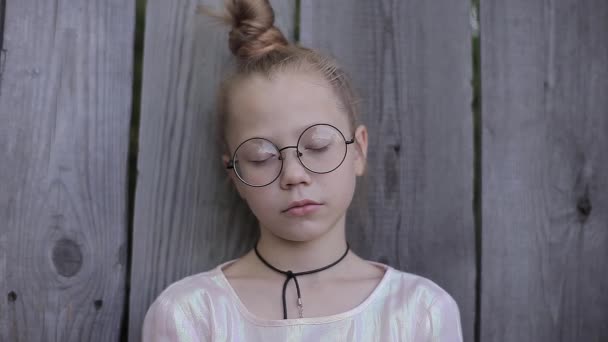 Mysterious Girl Stands on the Background of the Fence With Closed Eyes — Stock Video