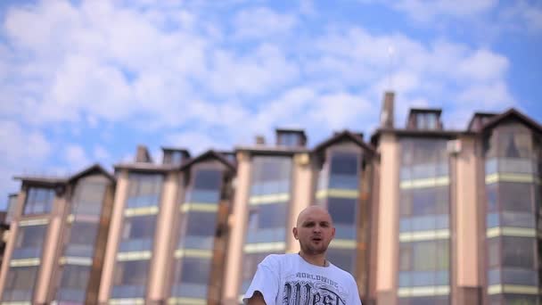 Serious Nervous Guy Rapping on the Street Near the Building Against the Sky — Stock Video