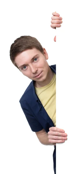 Young man posing next to a banner — Stock Photo, Image