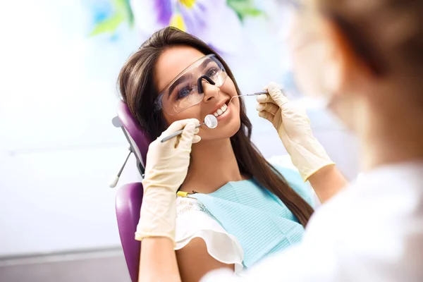Woman during a dental procedure. - https://st2.depositphotos.com/7375876/12335/i/450/depositphotos_123352672-stock-photo-overview-of-dental-caries-prevention.jpg