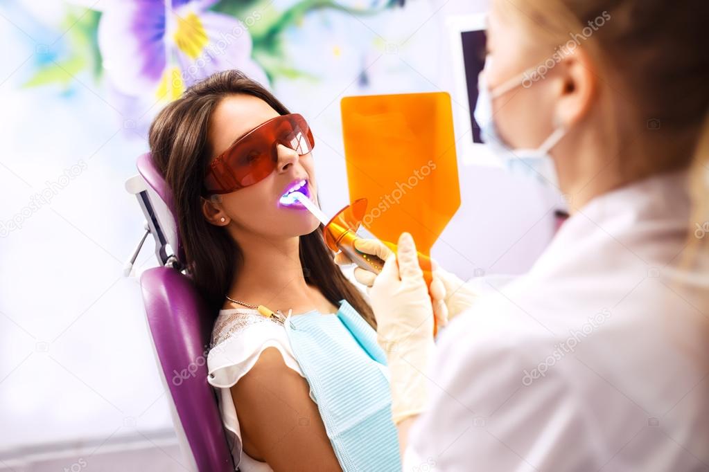 Overview of dental caries prevention.Woman at the dentist's chair during a dental procedure. Beautiful Woman smile 