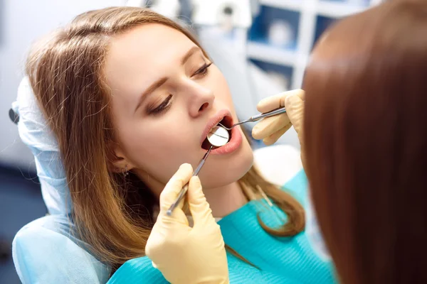 Overview of dental caries prevention.Woman at the dentist\'s chair during a dental procedure.