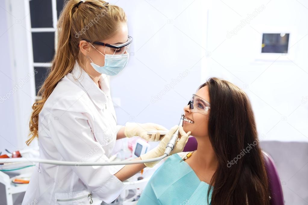 Overview of dental caries prevention.Woman at the dentist's chair during a dental procedure. 