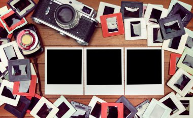 Film fotoğraf masanın üzerinde. Retro kamera ve ahşap masa üzerinde eski fotoğraflar. 