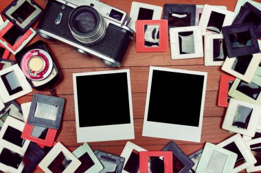 Film fotoğraf masanın üzerinde. Retro kamera ve ahşap masa üzerinde eski fotoğraflar. 