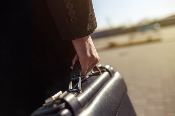 leather briefcase in his hand. young businessman 