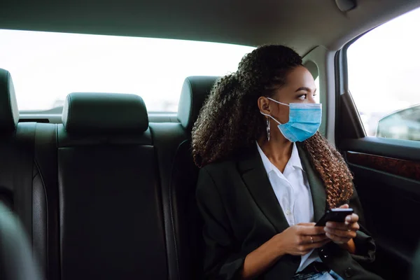 Relaxed Woman Passenger Protective Medical Mask Taxi Car Backseat Phone — Stock Photo, Image