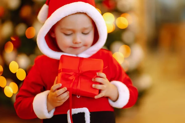 Smiling Funny Child Santa Costume Holds Christmas Present Hands Unexpected Stock Picture