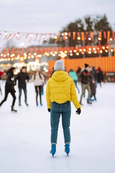 아름다운 여성이 크리스마스 이브에 광장에 경기장에서 재미있고 활기찬 아이스 스케이팅을 — 스톡 사진