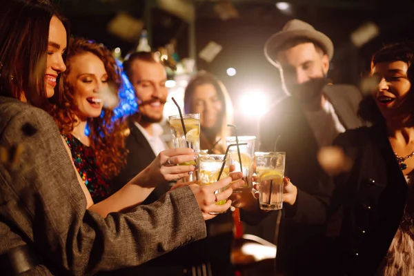 バーでは友人のグループで一緒にカクテルを応援し 飲んでいます 冬の休日をナイトクラブパーティーでカクテルと一緒に祝う若者 ライフスタイル 飲み物 誕生日のコンセプト — ストック写真
