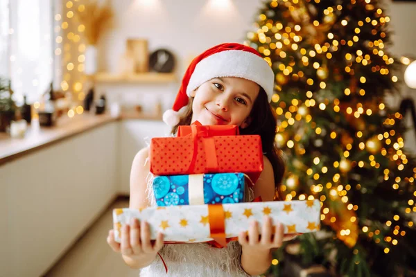 Happy Female Child Santa Red Hat Holding Christmas Gifts Smiling — Stock Photo, Image