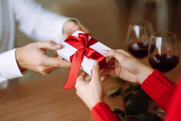 Exchange of gifts.  Young couple in love offering gift to each other for valentine day or birthday. Romantic day. Winter holidays.