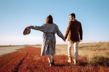 Genç çift bahar boyunca parkta yürür ve sarılırlar. Birlikte eğleniyoruz. Gençlik, aşk ve yaşam tarzı kavramı.