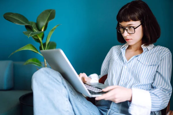 Jovem Freelancer Sentar Sofá Moderno Digitando Laptop Sala Estar Casa — Fotografia de Stock