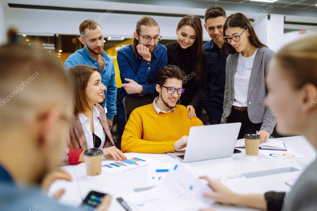 Business colleagues working together in creative office. Young people discuss financial result review paperwork share ideas brainstorm collaborate work in teamwork. Planning, analysis.