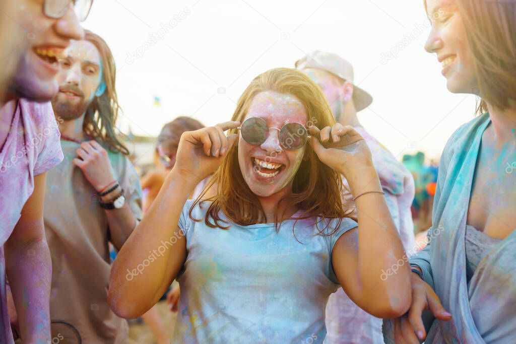 A group of friends have fun,  dance at the holi festival. Spring Break Beach Party. Celebrating traditional indian spring holiday. Friendship, Leisure, Vacation, Togetherness.