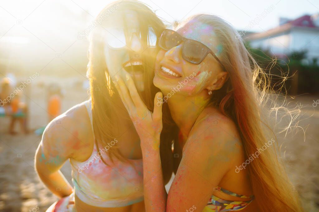 A group of friends have fun,  dance at the holi festival. Spring Break Beach Party. Celebrating traditional indian spring holiday. Friendship, Leisure, Vacation, Togetherness.
