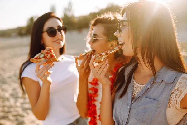 Trzy Młode Kobiety Jedzą Pizzę Bawią Się Plaży Koncepcja Fast — Zdjęcie stockowe