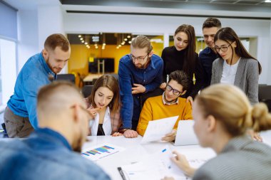 Başarılı bir takım. Yaratıcı ofiste çalışan ve iletişim kuran bir grup genç iş adamı. Beyin fırtınası konsepti. Takım çalışmasında planlama, eğitim, analiz, işbirliği.