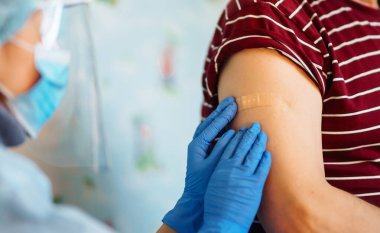 İnsanların bağışıklık sistemi için aşı konsepti. Covid-19. Doktor yaşlı hastayı evde aşılıyor. Sağlık, koronavirüs, önleme ve aşılama.