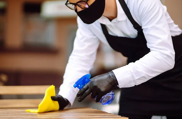Disinfecting Cafe Tables Prevent Covid Young Waiter Wearing Protective Face — ストック写真
