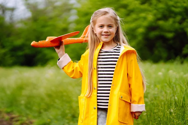 Menina Manto Amarelo Botas Borracha Lança Avião Brinquedo Para Céu — Fotografia de Stock