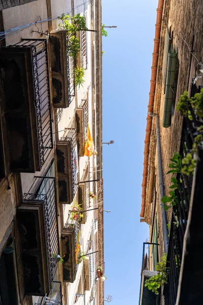 Узкая улица со старыми историческими домами с окнами, балконами в Барселоне — стоковое фото