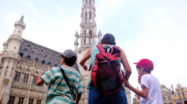 Güzel bir kadın ve küçük çocuklar şehirde yürüyor..