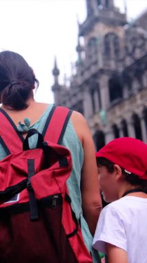 Sırt çantalı bir kadın ve küçük oğlu şehrin tarihi mimarisine hayran..