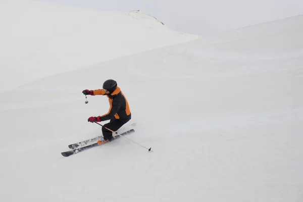 Sciatore sperando code mentre sciare in una pista da sci — Foto Stock