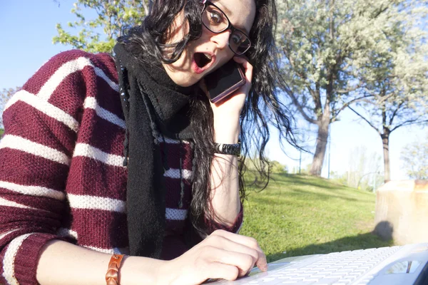 Woman surprised because of an information on the internet or by the phone — Stock Photo, Image