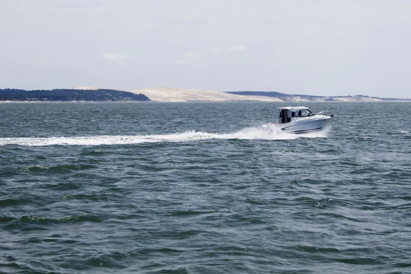 Μηχανοκίνητο σκάφος επιτάχυνση μπροστά Pilat dune στη Γαλλία Εικόνα Αρχείου