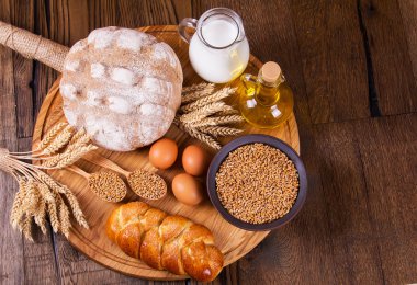 Ahşap masa arkasında pişmiş ekmek çeşitleri